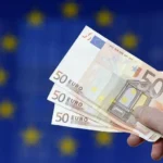 Traders watching European bond yield data on financial monitors.