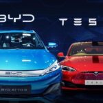 BYD electric car in Europe next to a Tesla Model 3